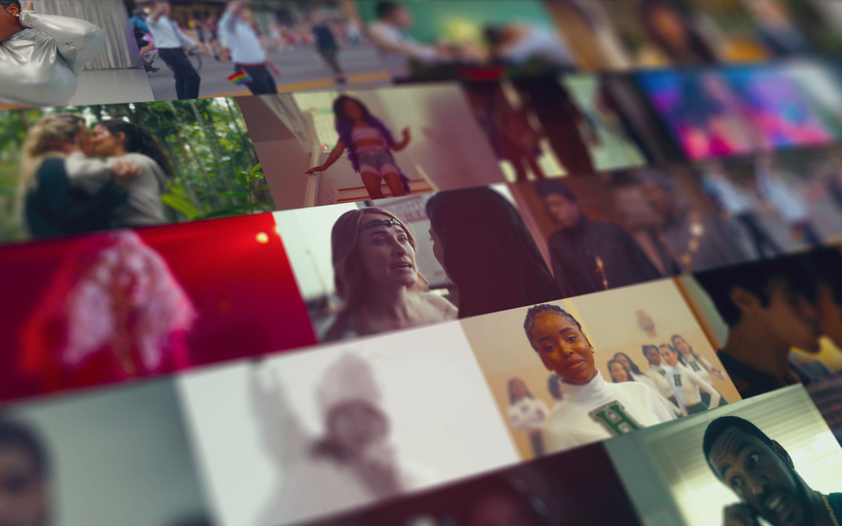 A wall of stills from the studio’s films and series, seen at an angle, from the open of the DEIA film