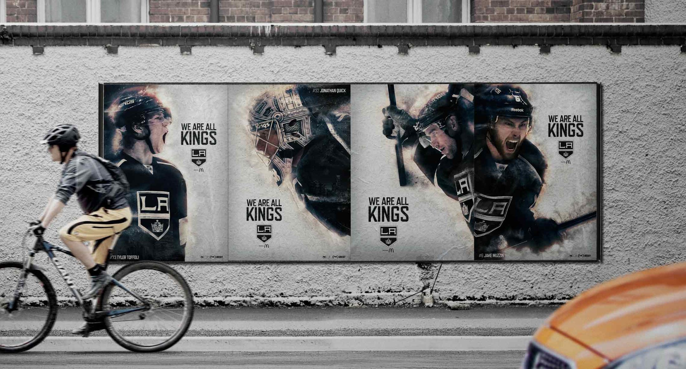 Three posters on a concrete wall as a cyclist rides past