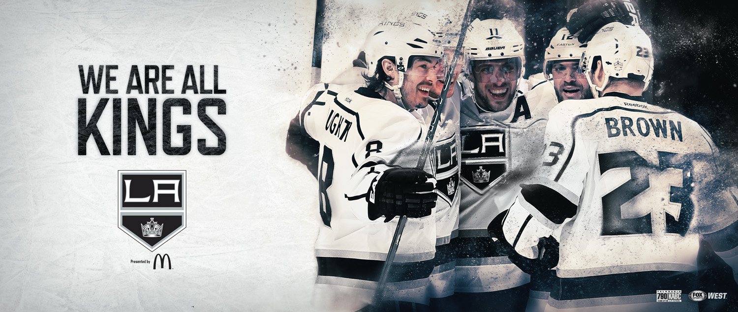 Doughty, Kopitar and Brown celebrating on a wide bulletin